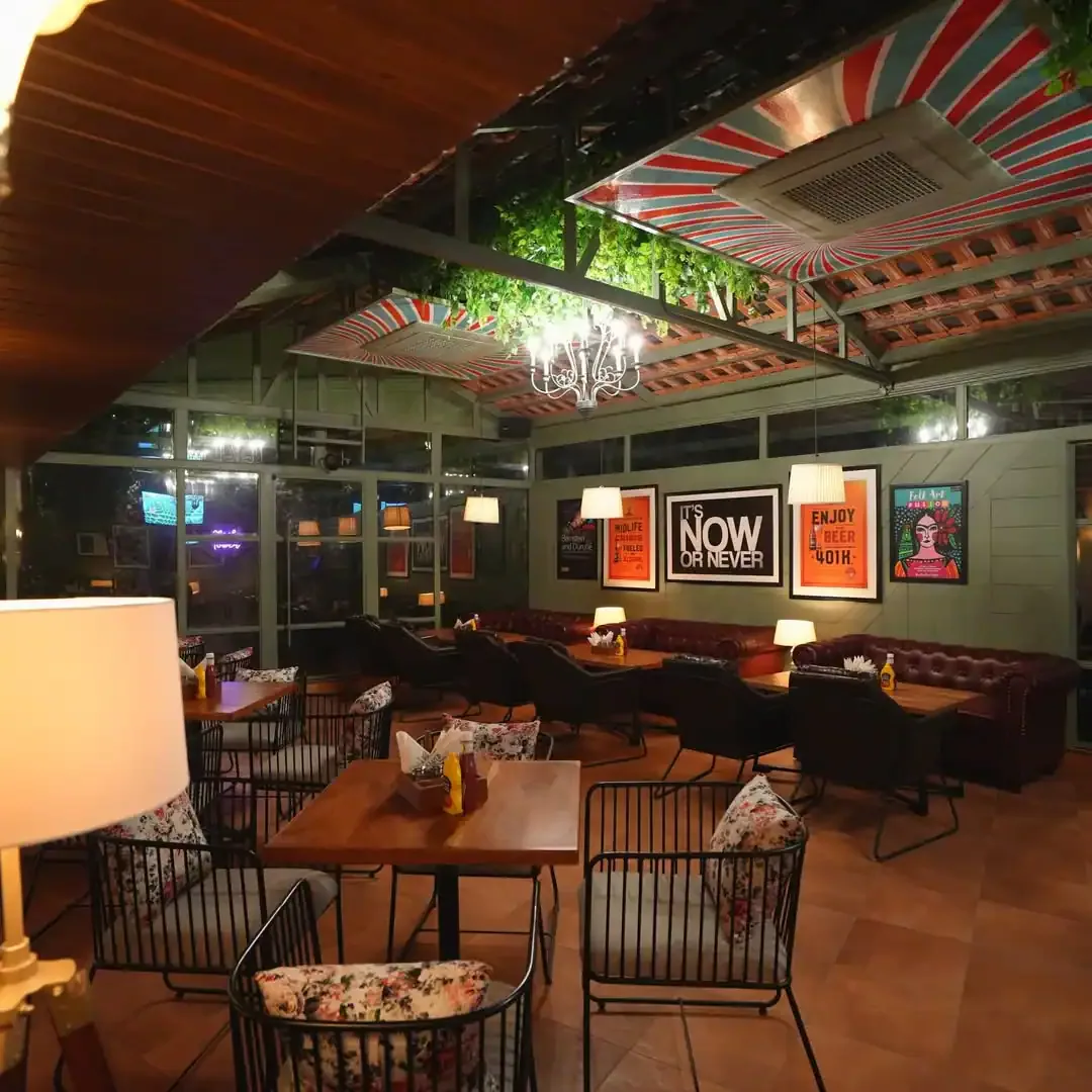 Posters, chandeliers and leather banquettes indoors