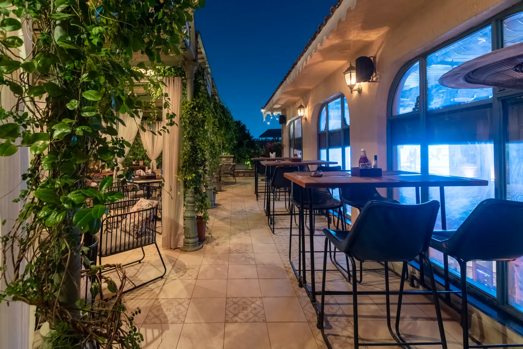 High tables along the terrace at dusk